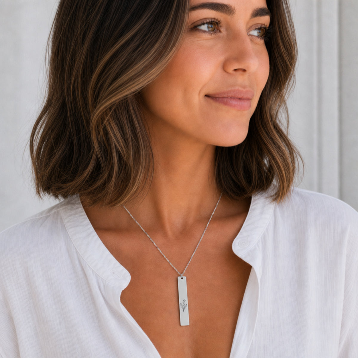 May birth flower necklace — Lily of the Valley engraved vertical bar pendant, Stainless Steel finish, model wearing pendant, on-neck lifestyle