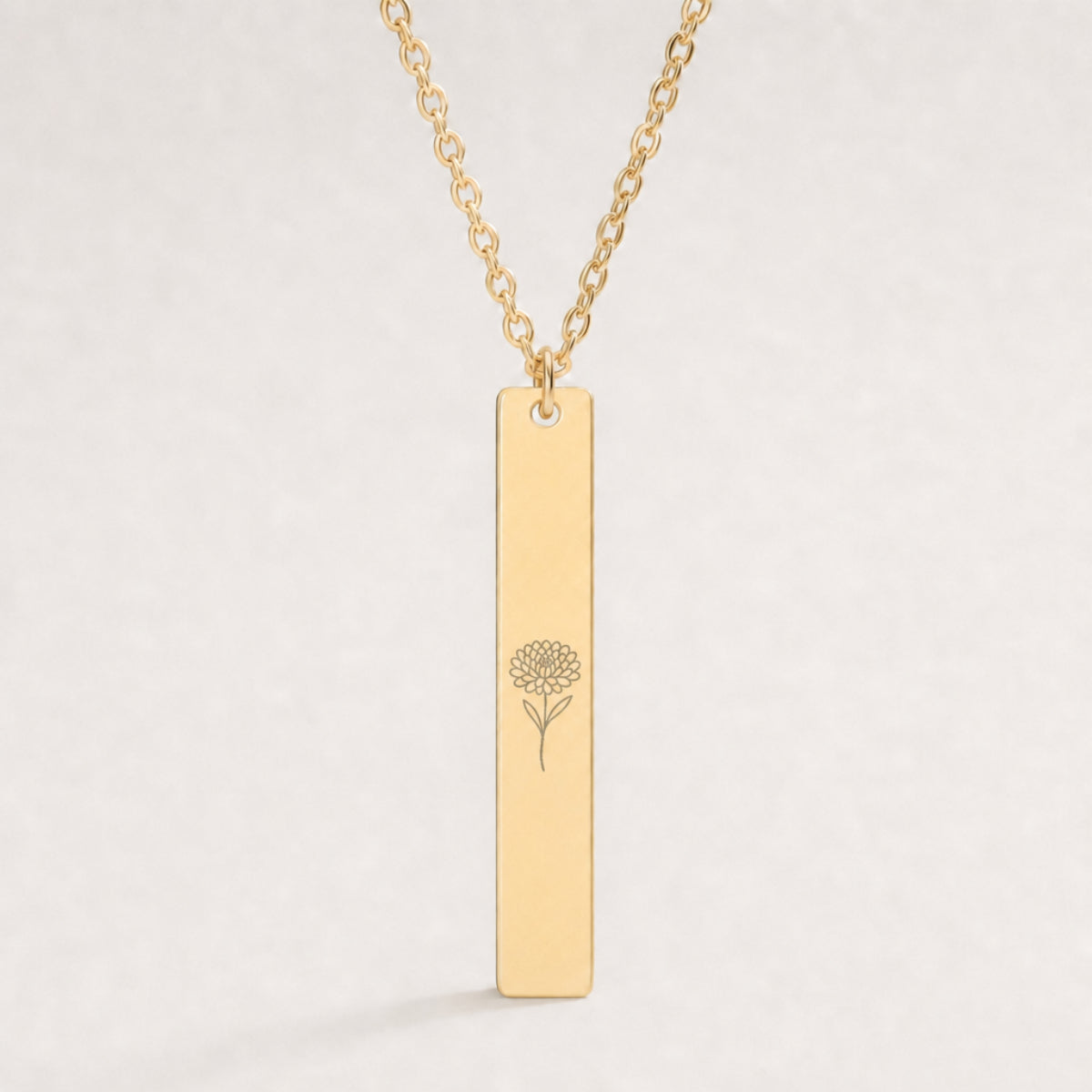 November birth flower necklace — Chrysanthemum engraved on 1.26" × 0.20" vertical bar pendant, premium close-up macro hero on 18K Gold PVD