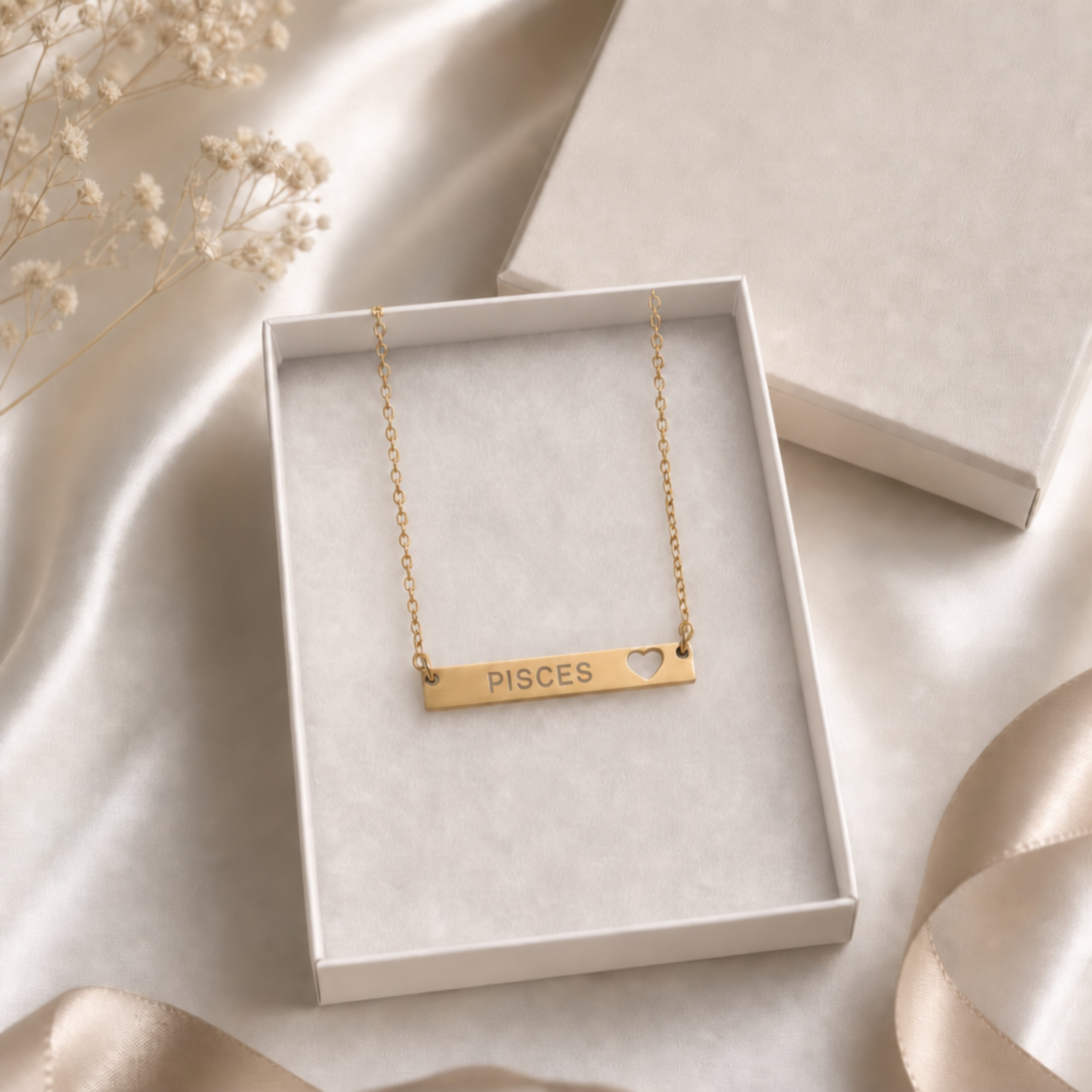 The Pisces zodiac necklace nestled in Memory That Lasts signature cream gift box — 18K Gold cutout heart bar pendant with grey laser-etched PISCES, satin lining, premium unboxing moment