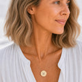 Pisces zodiac coin necklace worn on model in 18K gold — engraved Pisces Fish pendant resting on chest, layered everyday necklace, personalized birthday gift for Pisces, February March zodiac