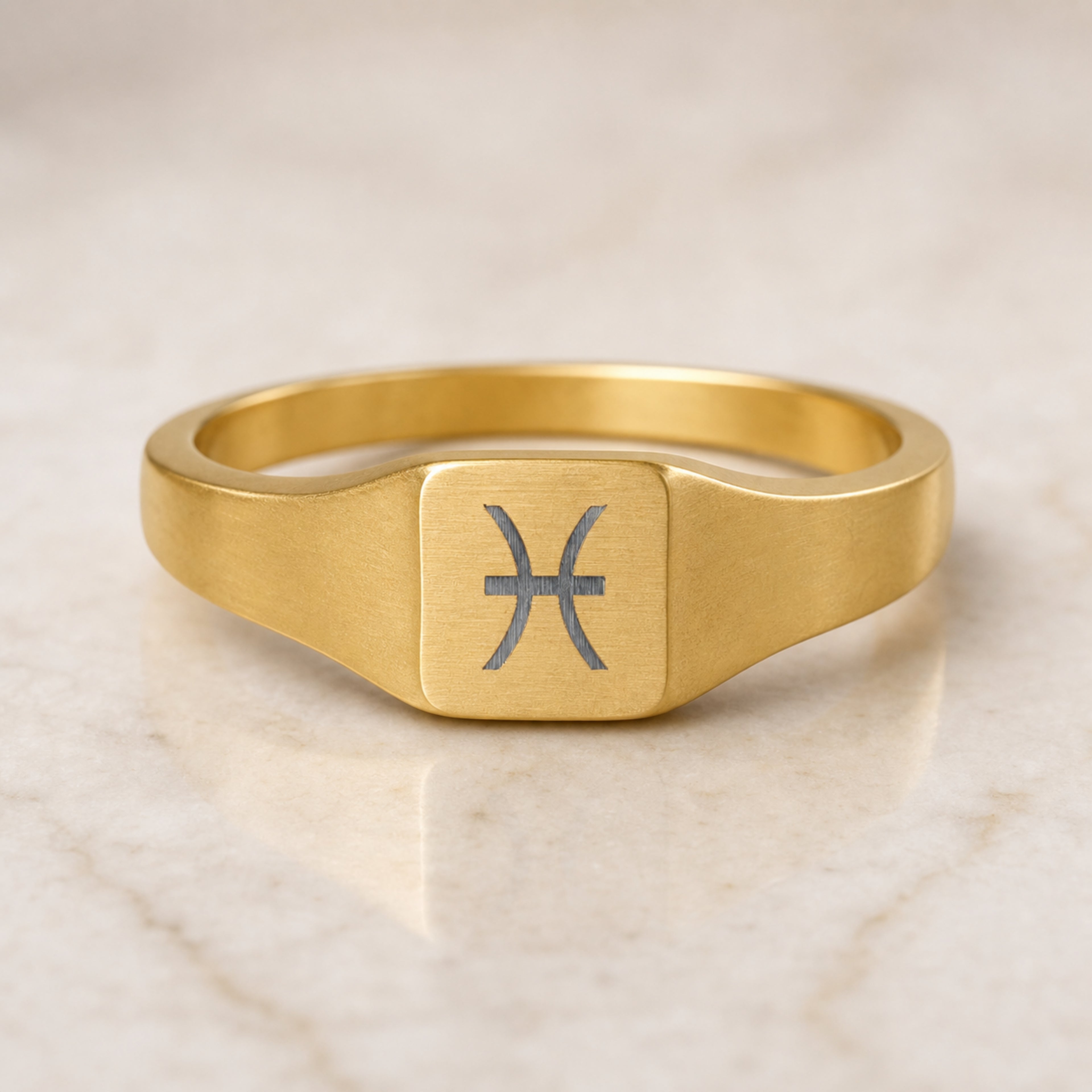 Pisces zodiac square signet ring — hero macro of laser-engraved Pisces glyph on 18K gold square face, premium personalized astrology ring gift