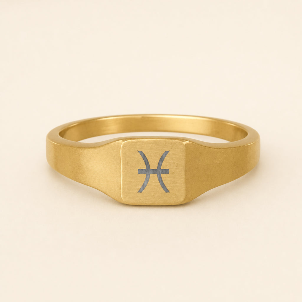 Pisces zodiac square signet ring studio front — clean cream backdrop product shot, 18K gold matte PVD