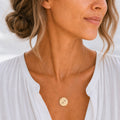 Sagittarius zodiac coin necklace lifestyle — 18K gold pendant with laser-engraved Sagittarius Archer glyph worn on model