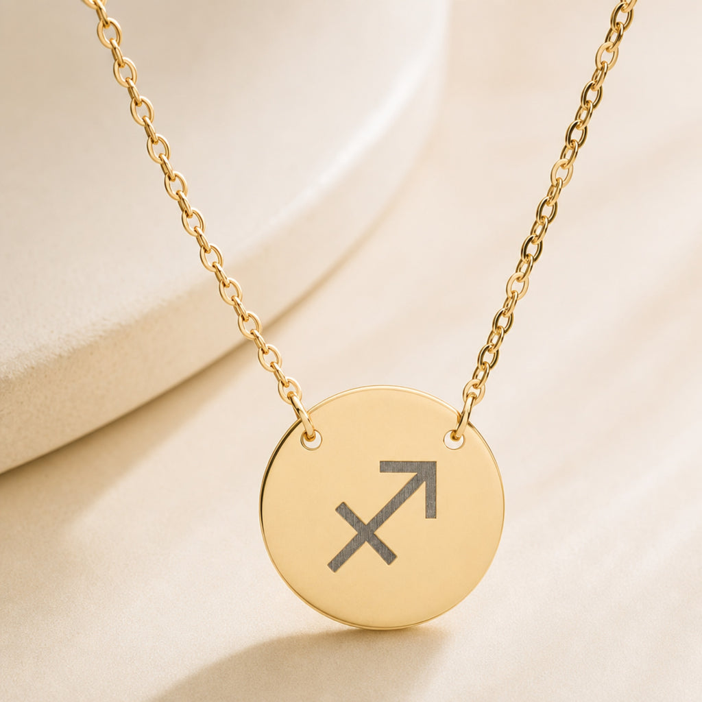 Sagittarius zodiac coin necklace close-up — detail of laser-engraved Sagittarius Archer glyph on 18K gold pendant