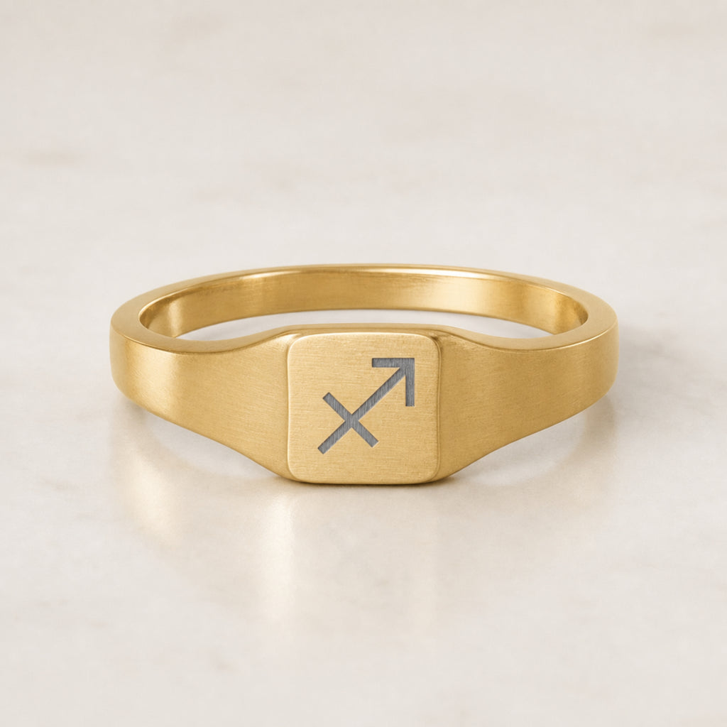 Sagittarius zodiac square signet ring — hero macro of laser-engraved Archer on 18K gold square face, premium personalized astrology ring gift