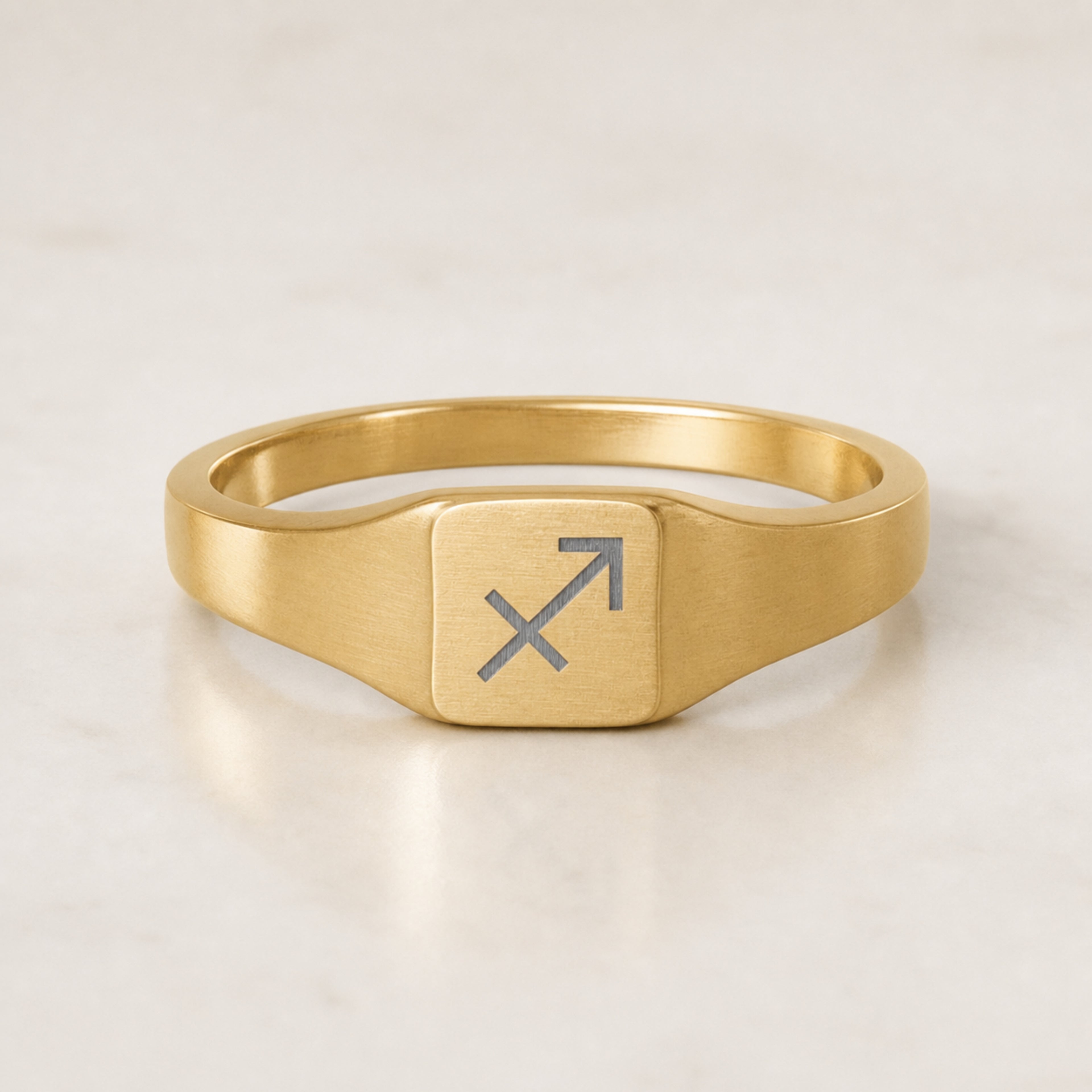 Sagittarius zodiac square signet ring — hero macro of laser-engraved Archer on 18K gold square face, premium personalized astrology ring gift