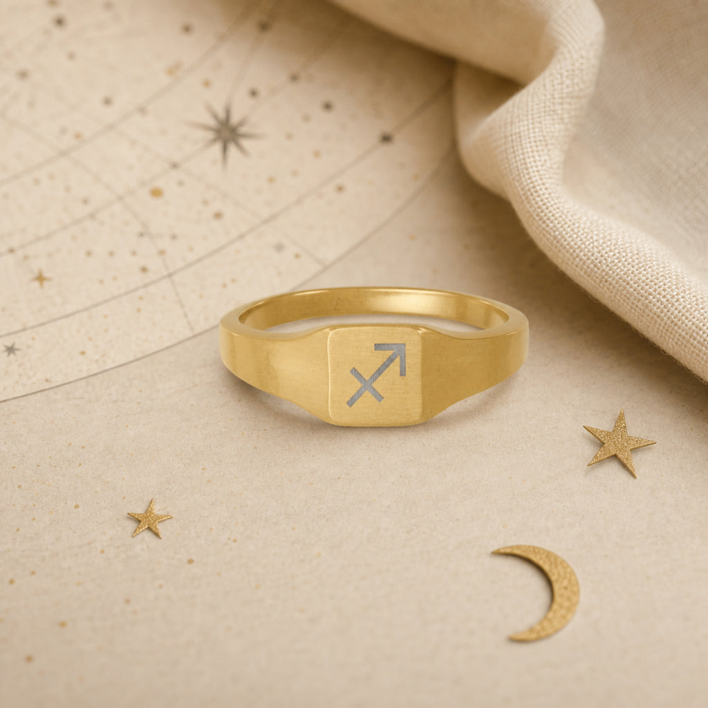 Sagittarius zodiac square signet ring celestial flatlay — zodiac chart and brass star with engraved Sagittarius signet, astrology gift styling