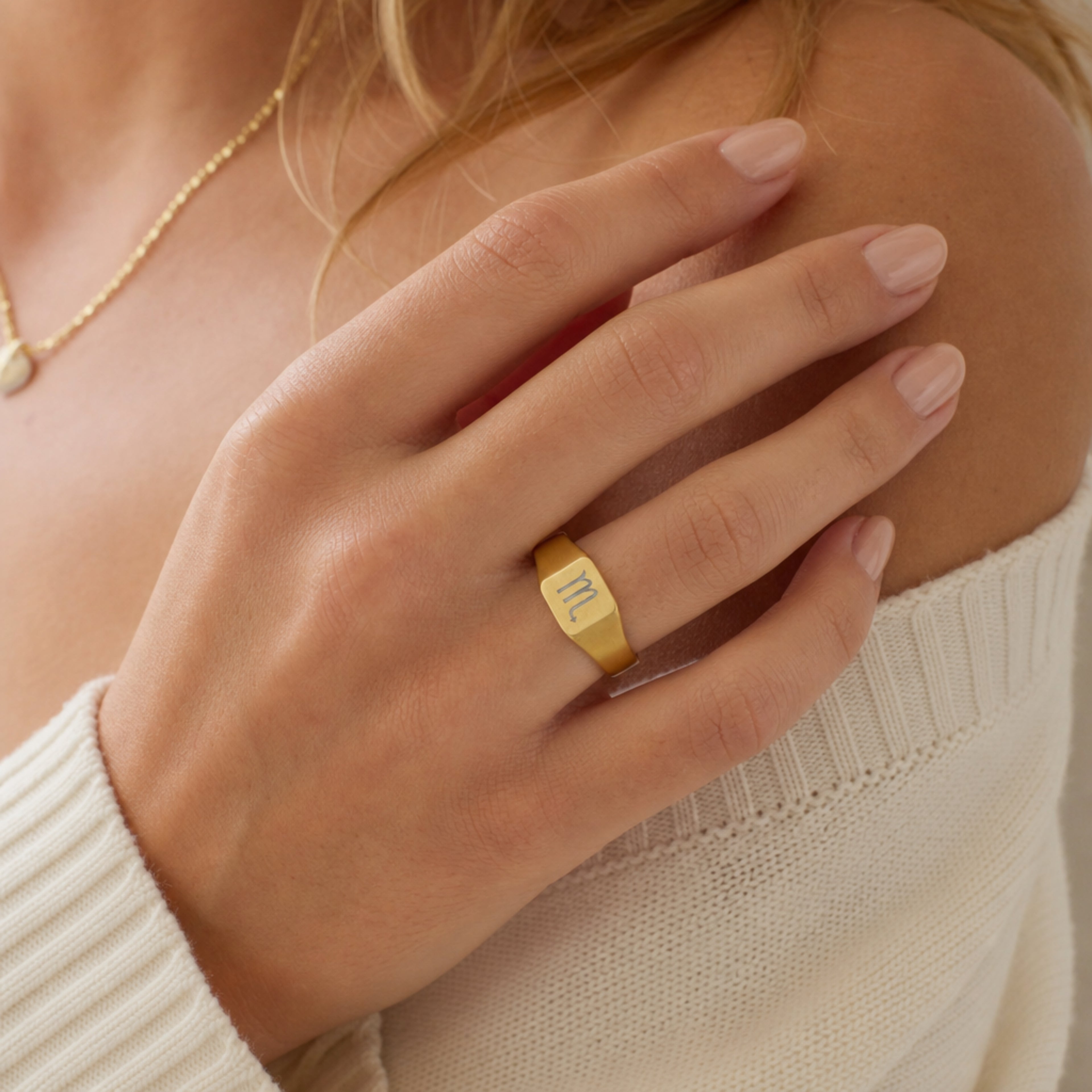 Scorpio zodiac square signet ring studio front — clean cream backdrop product shot, 18K gold matte PVD
