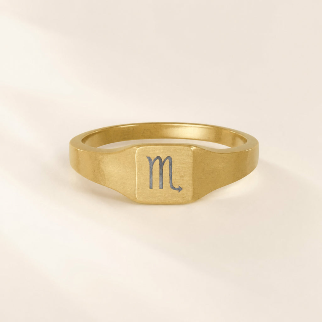 Scorpio zodiac square signet ring engraving close-up — laser-etched Scorpion detail, brushed grey on matte gold