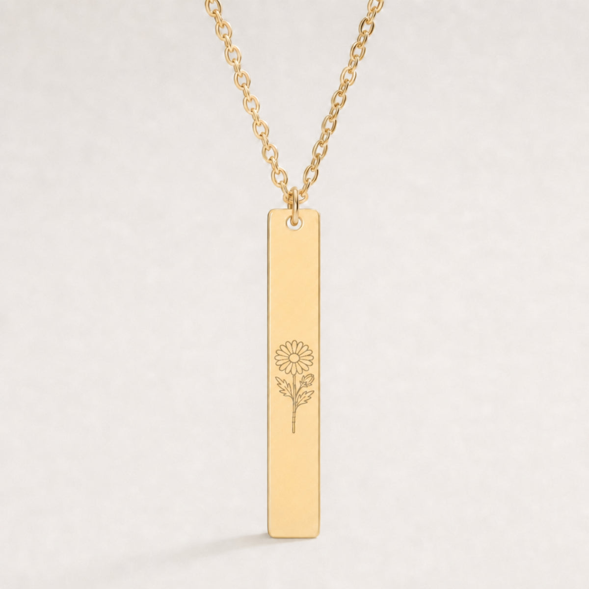 September birth flower necklace — Aster engraved on 1.26" × 0.20" vertical bar pendant, premium close-up macro hero on 18K Gold PVD