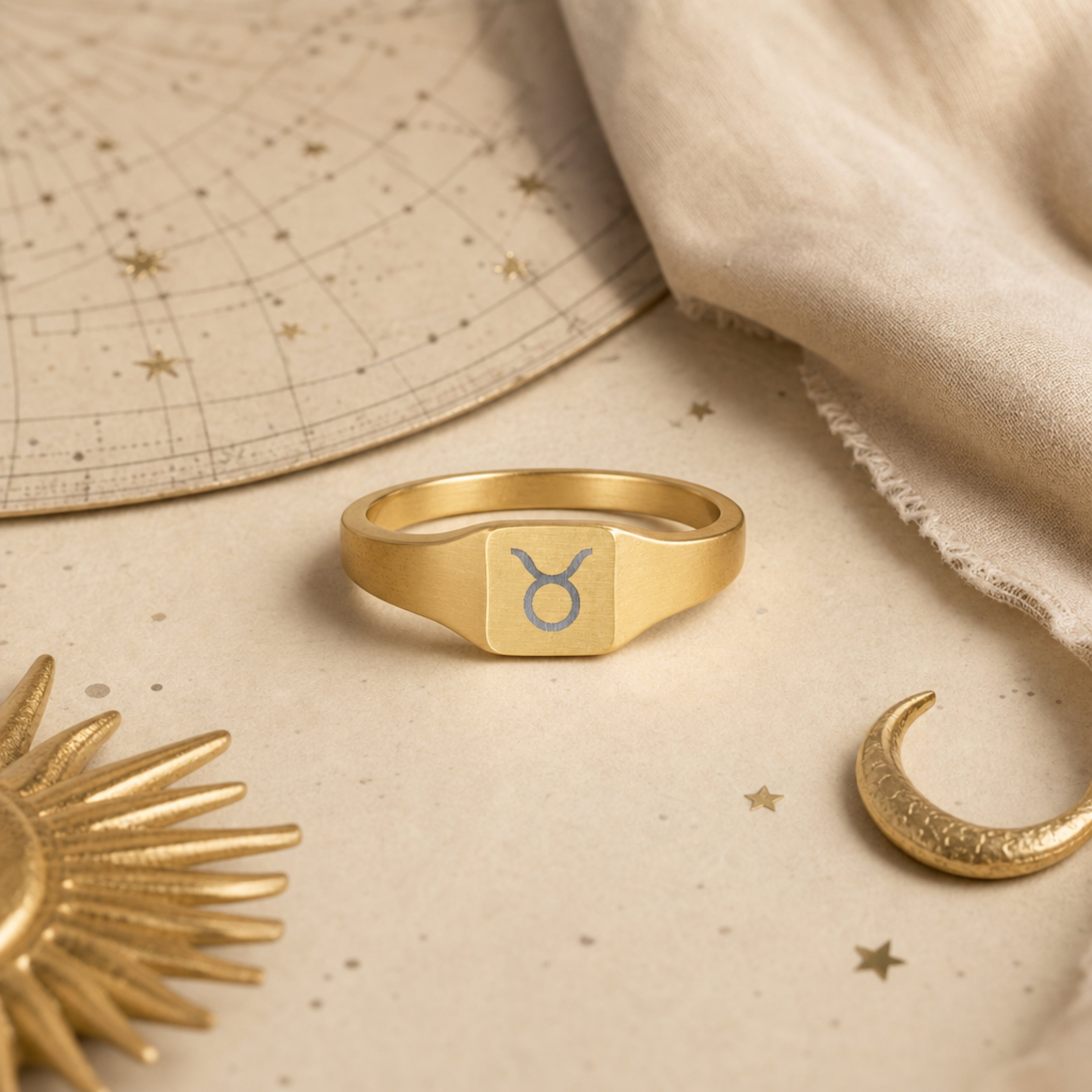 Taurus zodiac square signet ring celestial flatlay — zodiac chart and brass star with engraved Taurus signet, astrology gift styling