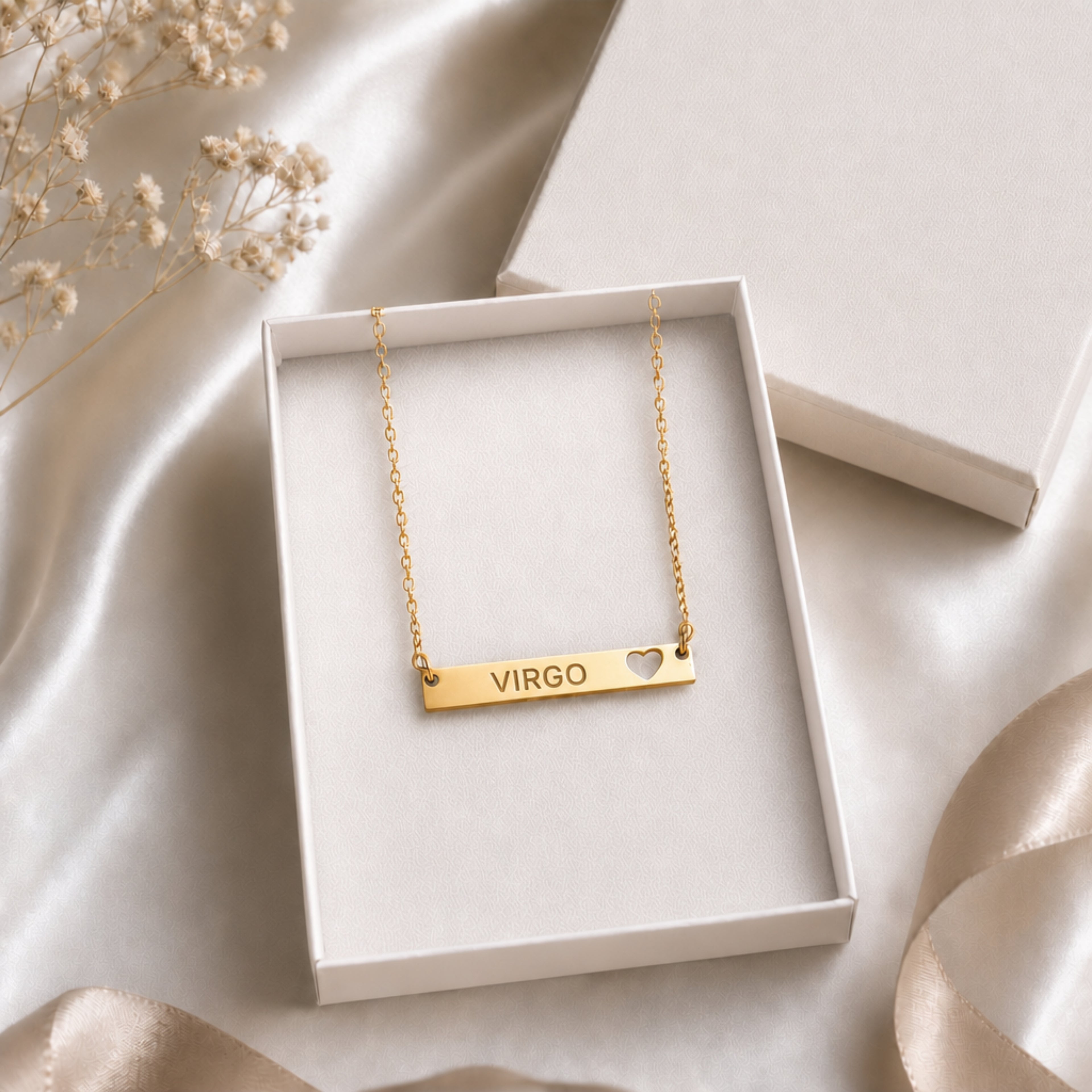 The Virgo zodiac necklace nestled in Memory That Lasts signature cream gift box — 18K Gold cutout heart bar pendant with grey laser-etched VIRGO, satin lining, premium unboxing moment