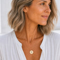 Virgo zodiac coin necklace worn on model in 18K gold — engraved Virgo Maiden pendant resting on chest, layered everyday necklace, personalized birthday gift for Virgo, August September zodiac
