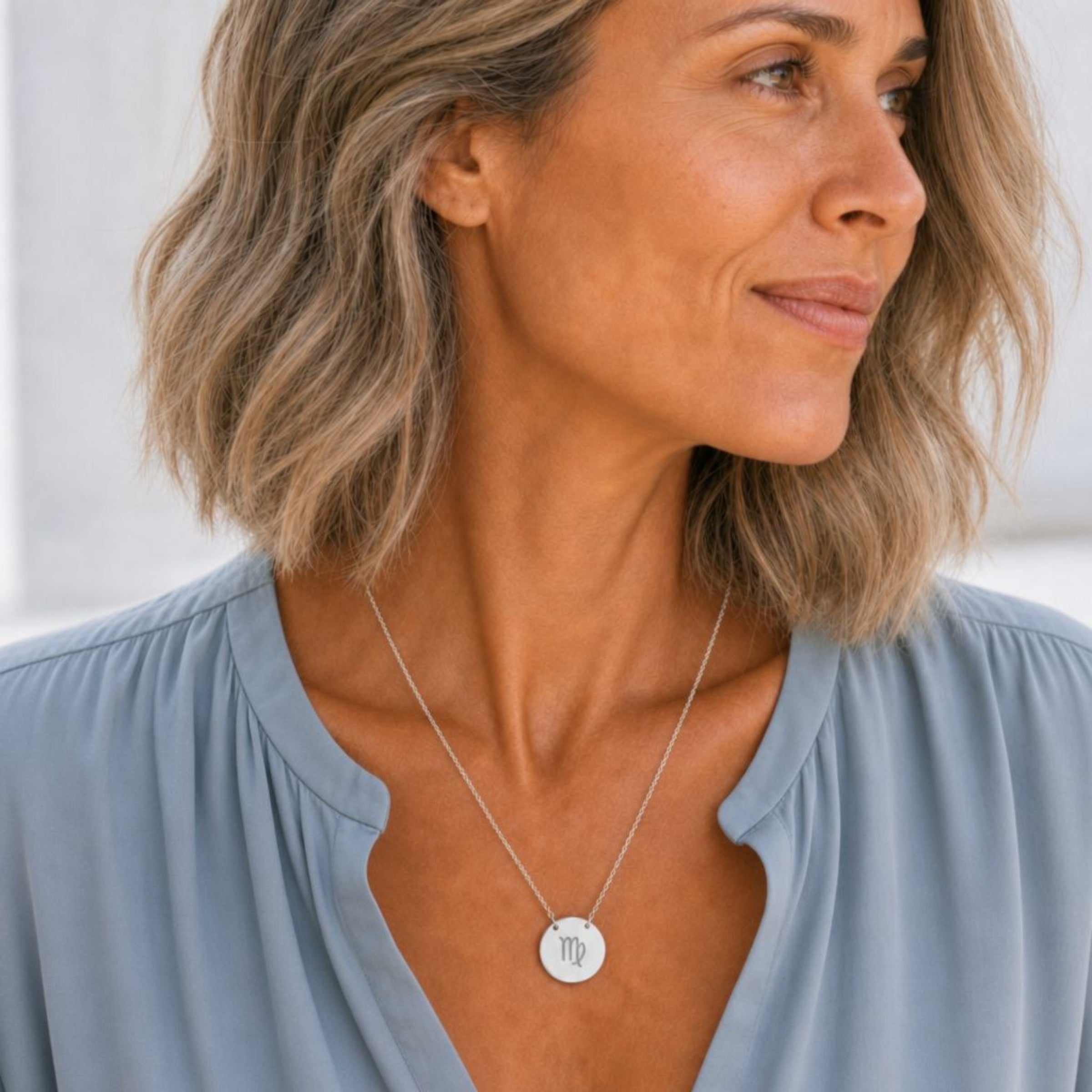 Virgo zodiac coin necklace in stainless steel worn on model — hypoallergenic Virgo Maiden pendant, polished steel disc necklace, everyday personalized astrology gift