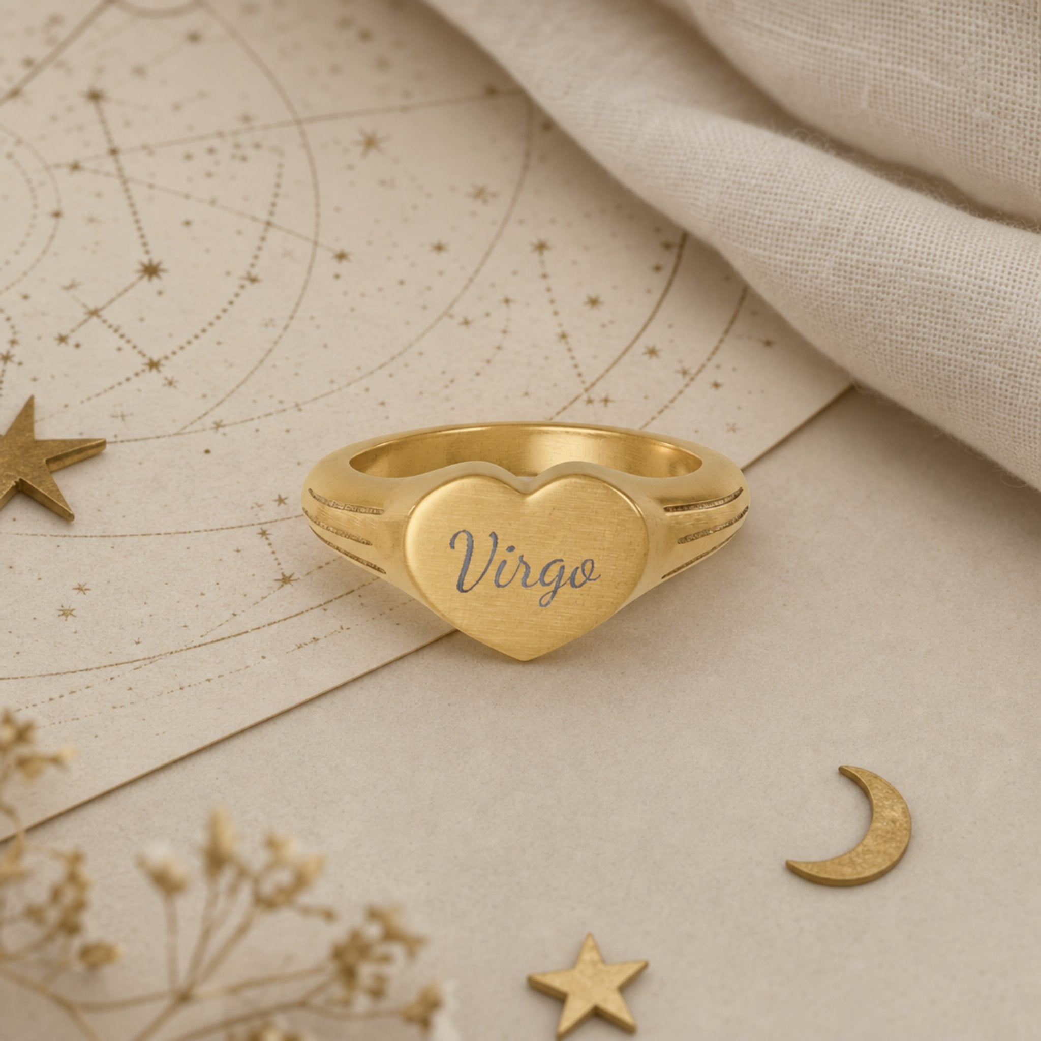 Virgo zodiac heart signet ring celestial flatlay — zodiac chart and brass star with engraved Virgo heart signet, astrology gift styling