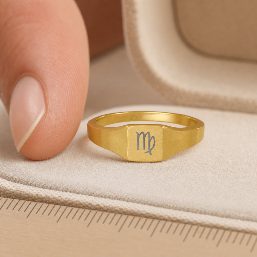 Virgo zodiac square signet ring scale-in-hand — fingers holding ring next to gift box and ruler, dainty 20mm signet sizing