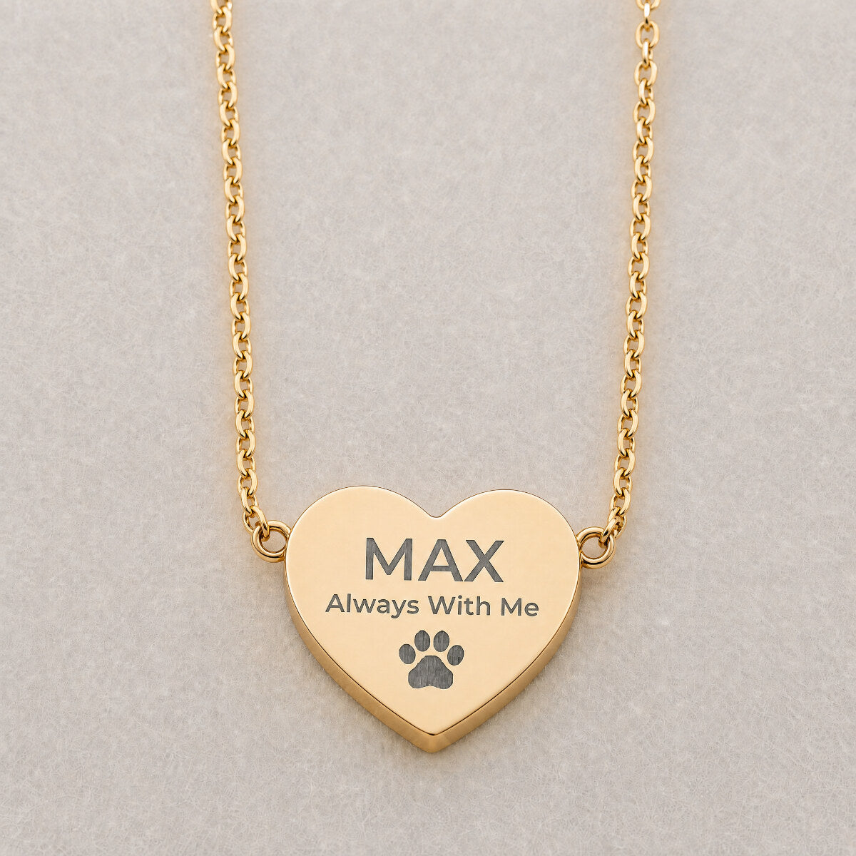 Always With Me heart pendant engraving close-up — laser-etched pet name detail on cream linen