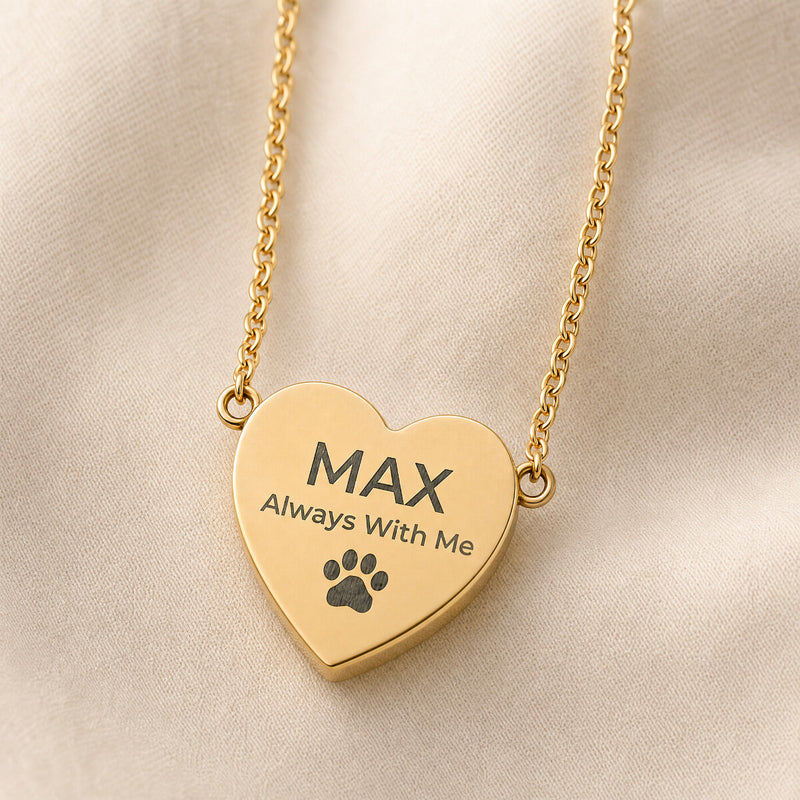 Gold pet memorial heart necklace engraved with a pet name, the words Always With Me, and a paw print