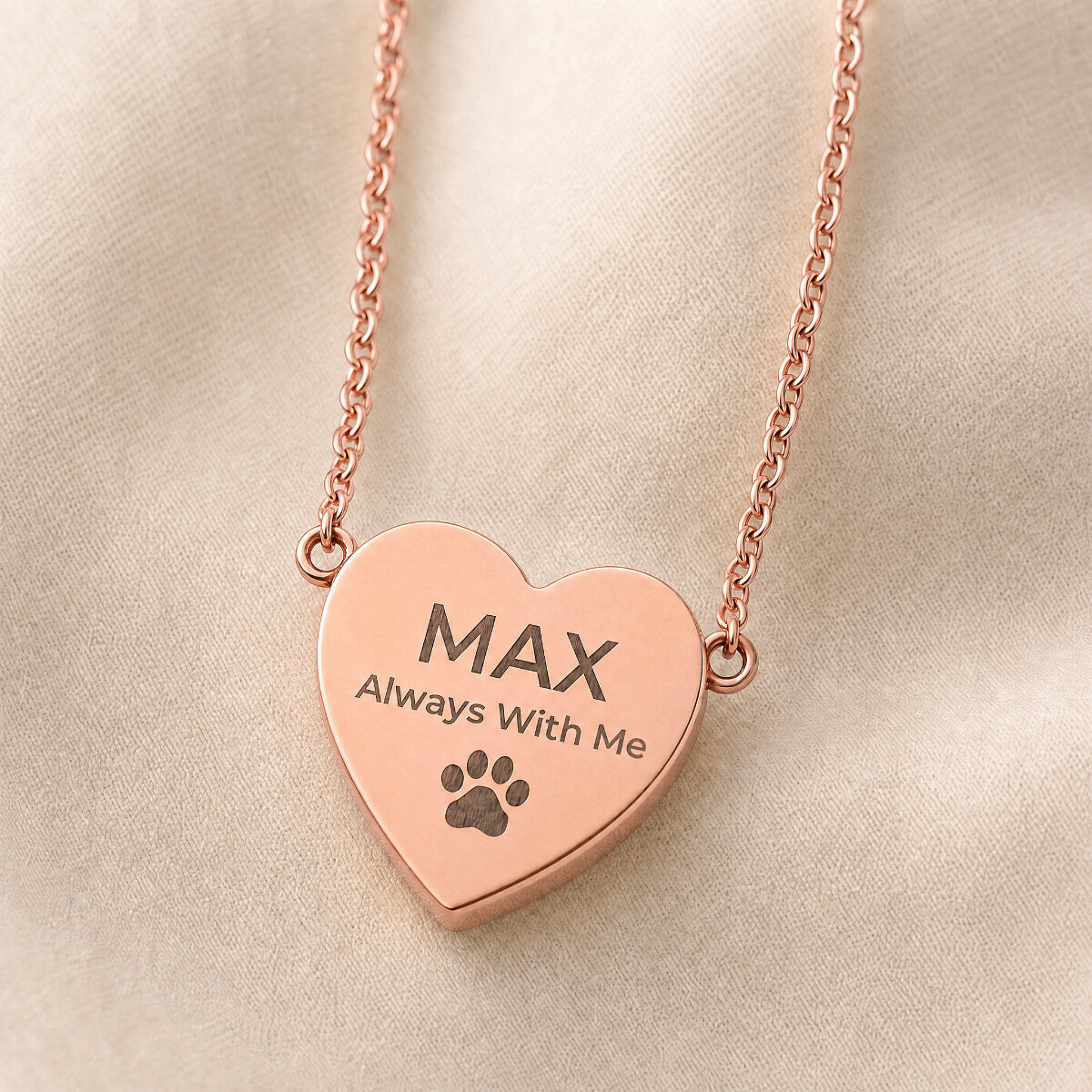 Always With Me heart pendant in 18K rose gold — close-up on cream linen