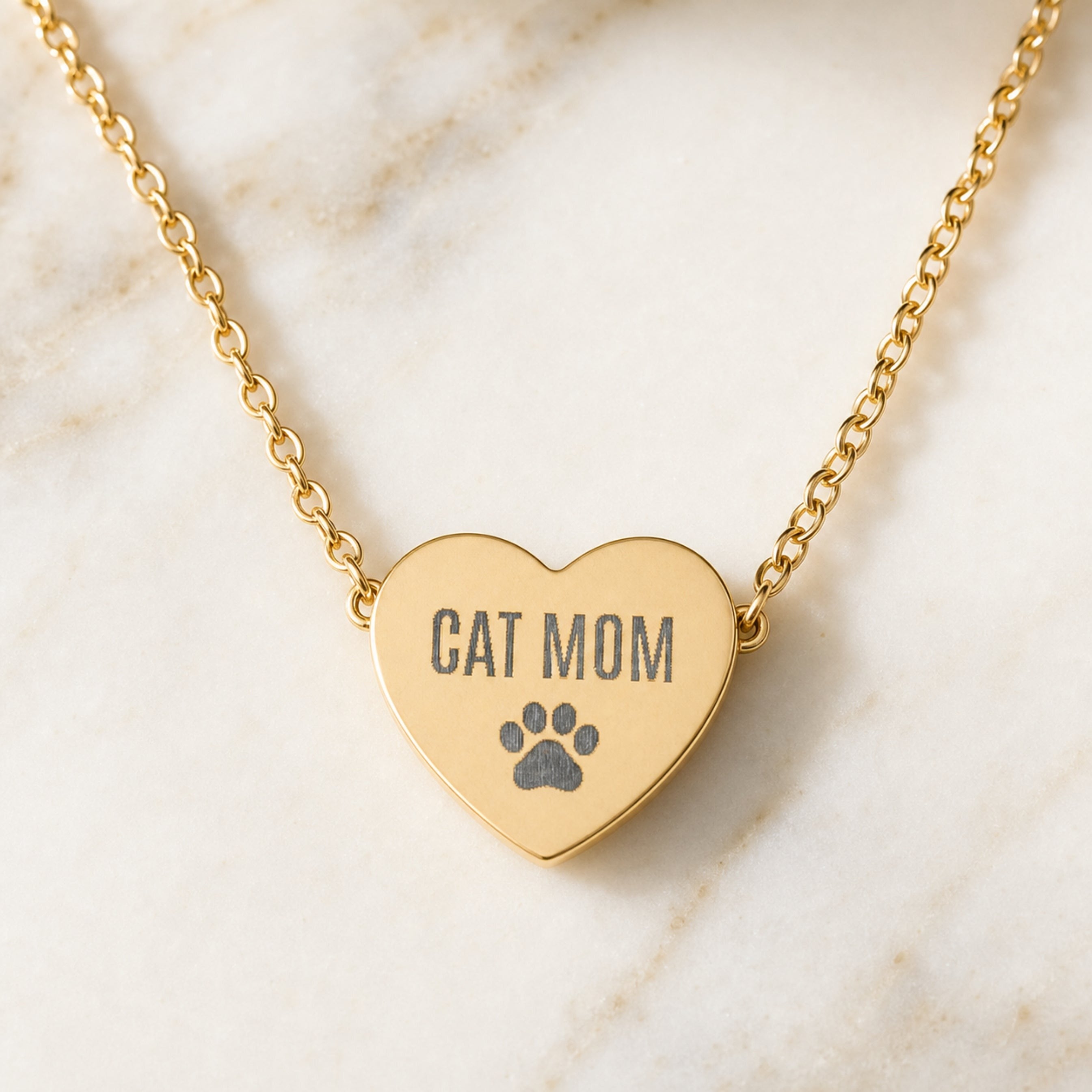Gold Cat Mom heart necklace with engraved paw print pendant