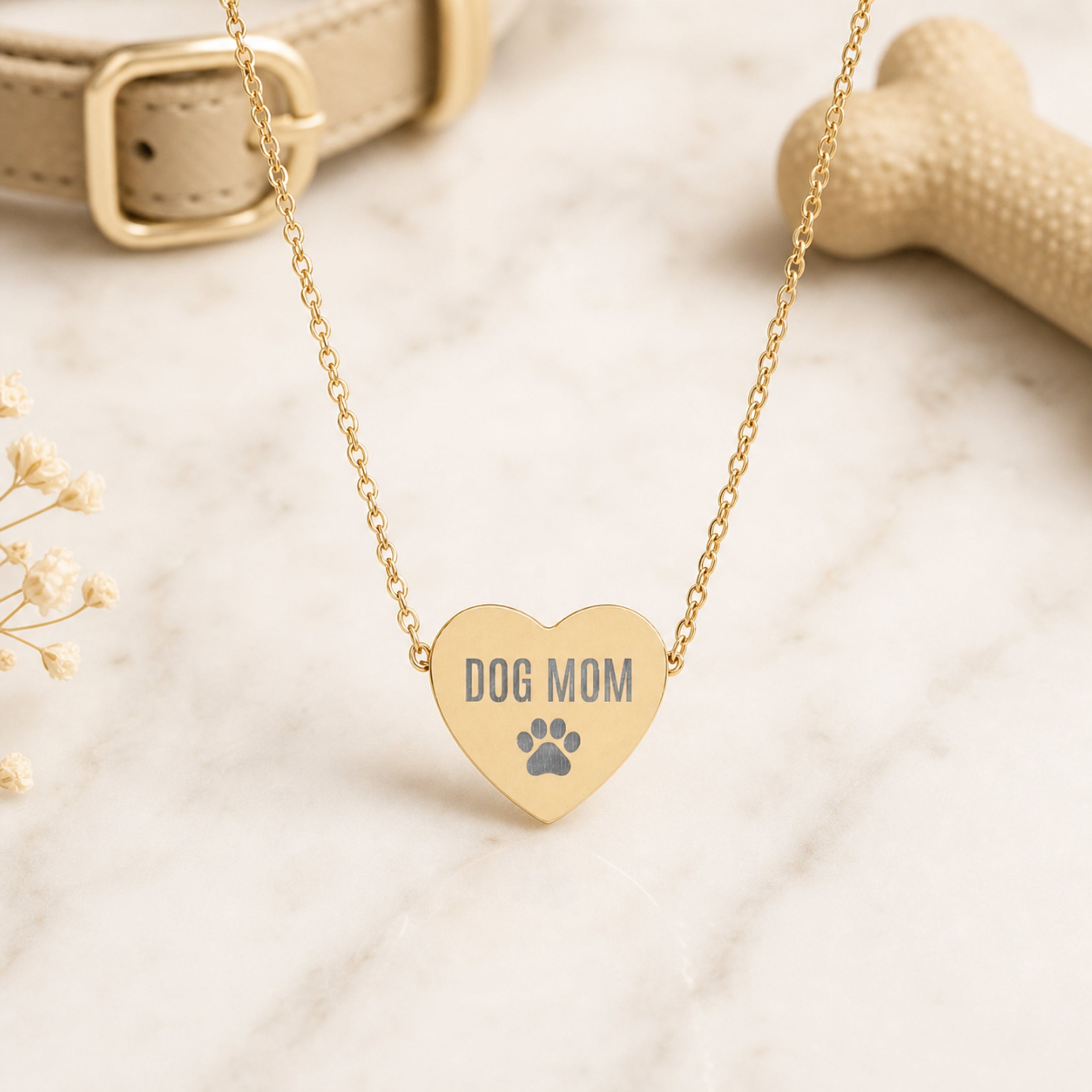 Gold Dog Mom paw print heart necklace flat lay