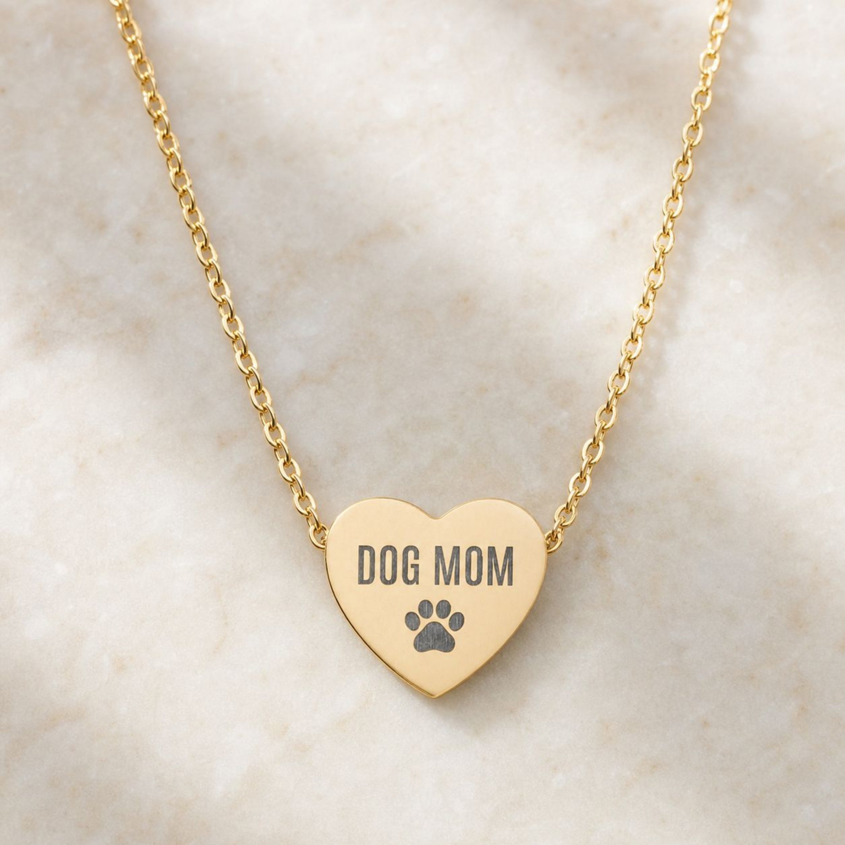 Gold Dog Mom heart necklace with engraved paw print pendant