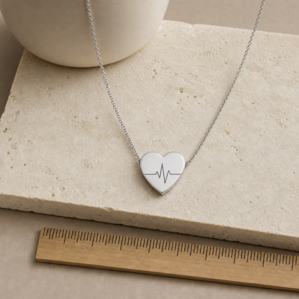 Rose gold heartbeat heart necklace, warm-tone styling on the engraved EKG pendant. Memory That Lasts.