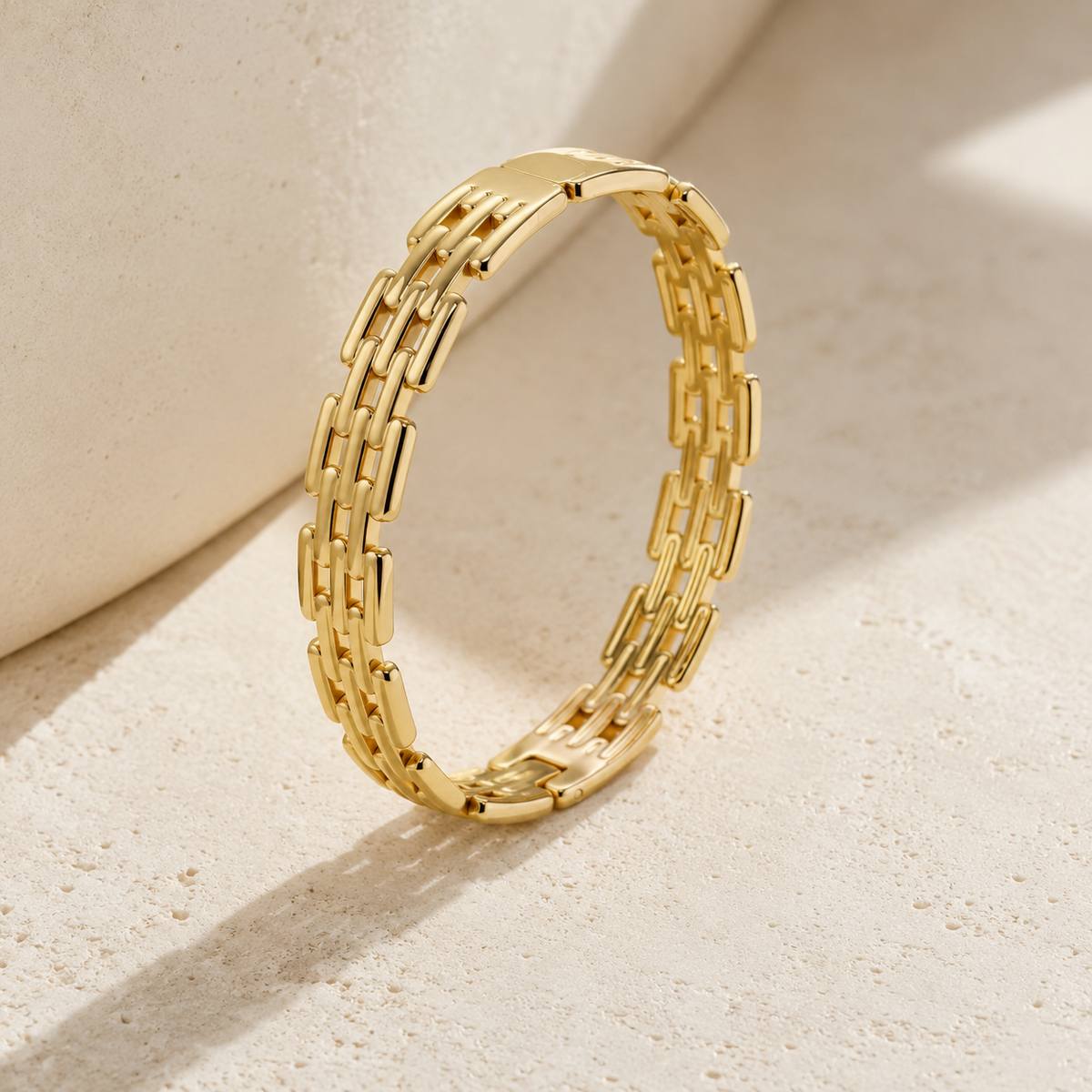 Gold Grid Link bracelet with three staggered rows on ivory limestone