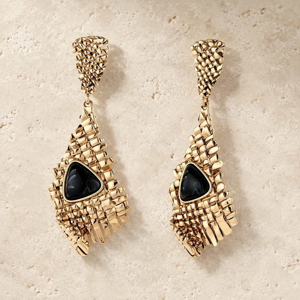 Grid Statement Earrings with glossy black triangular centers, woven gold mesh, and rectangular fringe