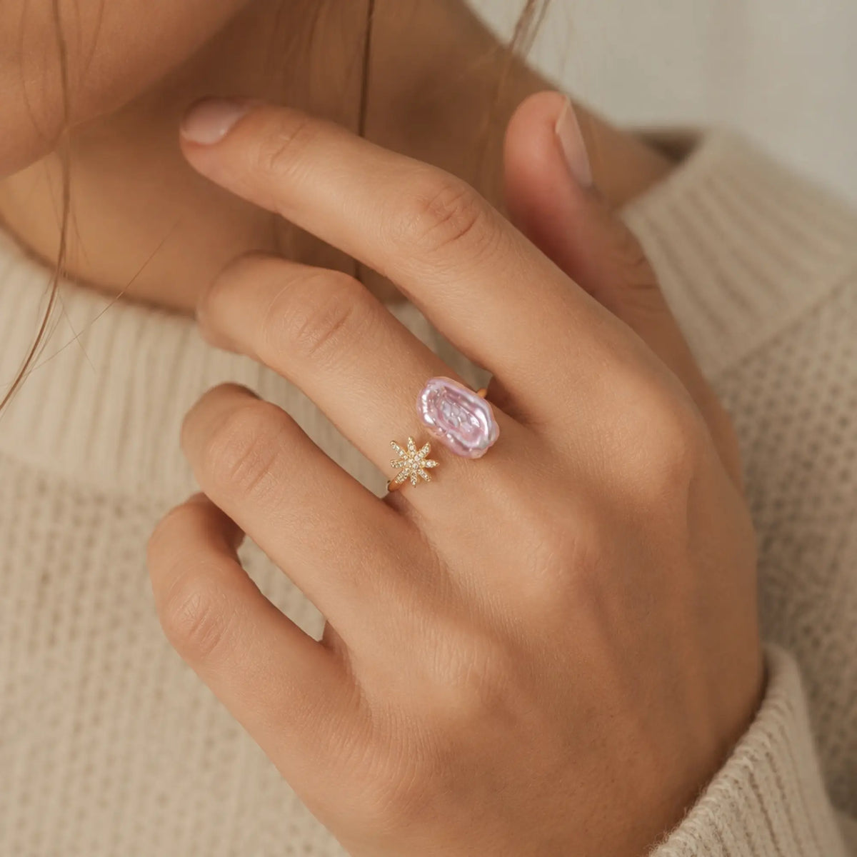 Starlit Pearl Dreams gold open ring with pink baroque pearl and crystal starburst worn on a hand